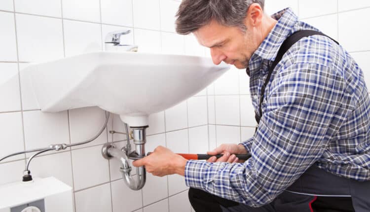 Mature,Male,Plumber,Fitting,Sink,Pipe,In,Bathroom